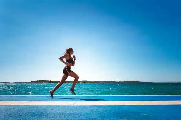 Woman running showing strong leg muscle Thame